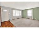 Bright living room featuring neutral walls, plush carpet, and large windows with natural light at 3322 N Riley N Ave, Indianapolis, IN 46218