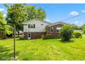 A spacious backyard with a lush green lawn and mature trees at 3388 S Leonard Rd, New Palestine, IN 46163