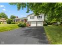 Charming split-level home featuring a brick facade and a spacious driveway at 3388 S Leonard Rd, New Palestine, IN 46163