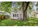 Backyard view of a single-story home with mature trees and a shed at 4034 N Temple Ave, Indianapolis, IN 46205