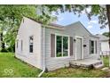 Side view of a charming single-story home with stone facade and a cozy front porch at 4034 N Temple Ave, Indianapolis, IN 46205