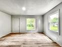 Bright, freshly painted living room with new wood flooring and ample natural light at 4034 N Temple Ave, Indianapolis, IN 46205