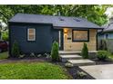 Well-maintained home with dark wood, eye-catching light wood accents, and manicured landscaping at 4245 Norwaldo Ave, Indianapolis, IN 46205