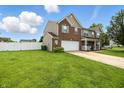 Beautiful home featuring an attached garage and lush green lawn at 5063 Haywood Ln, Plainfield, IN 46168
