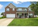 Charming two-story brick home with a welcoming front porch and manicured lawn at 5063 Haywood Ln, Plainfield, IN 46168