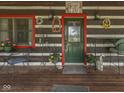 Inviting front porch featuring rustic decor, a seating area, and a charming welcome sign at 5240 W 400 N, Fairland, IN 46126