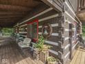 Inviting log home porch with comfortable seating and rustic decor at 5240 W 400 N, Fairland, IN 46126