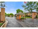 Inviting community entrance featuring a brick guard house and mature trees, creating a welcoming atmosphere at 526 W Hunters Dr # C, Carmel, IN 46032