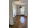 This dining area features hardwood floors and a stylish light fixture at 5378 Rosslyn Ave, Indianapolis, IN 46220