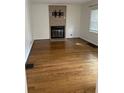 Spacious living room boasts hardwood floors, neutral paint, and a cozy fireplace at 5378 Rosslyn Ave, Indianapolis, IN 46220
