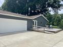 View of backyard with accessible ramp, patio, large garage and mature landscaping at 540 Lazy Ln, Greenwood, IN 46142