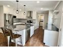 Bright kitchen with stainless steel appliances, gray backsplash, and granite countertops at 540 Lazy Ln, Greenwood, IN 46142