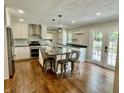 Spacious kitchen featuring modern appliances, center island with seating, and beautiful wood floors at 540 Lazy Ln, Greenwood, IN 46142