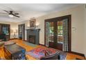 Cozy living room featuring a decorative fireplace, hardwood floors, and natural light at 5424 Broadway St, Indianapolis, IN 46220