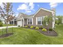 Beautiful home featuring manicured lawn, a brick facade and white trim at 5723 Arctic Run Dr, Noblesville, IN 46062
