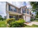 Attractive two-story home with lush greenery, enhancing the curb appeal and creating a welcoming entrance at 5859 Edelle Dr, Indianapolis, IN 46237