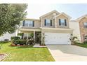 Two-story home with attached garage and manicured lawn at 5859 Edelle Dr, Indianapolis, IN 46237