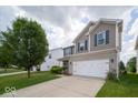 A well-kept two-story home with a spacious lawn, offering a welcoming curb appeal at 5859 Edelle Dr, Indianapolis, IN 46237