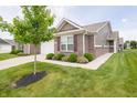 Attractive home featuring brick and siding, green lawn, and tidy landscaping, creating curb appeal at 610 Sawtooth St, Westfield, IN 46074