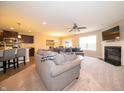 Inviting open-concept living space with fireplace, TV, and modern finishes connected to the kitchen at 610 Sawtooth St, Westfield, IN 46074
