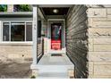 Close-up of the home's entrance, featuring a red door and stone facade at 6146 Burlington Ave, Indianapolis, IN 46220