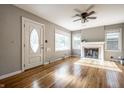 Bright living room with hardwood floors, fireplace, ceiling fan, and natural light at 6146 Burlington Ave, Indianapolis, IN 46220
