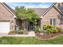 Close-up of the house's entrance, landscaped front garden, and brick facade at 6528 Fountain Springs Blvd, Indianapolis, IN 46236