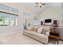 Inviting living room with high ceilings, large windows, and a comfortable sofa at 6528 Fountain Springs Blvd, Indianapolis, IN 46236