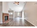 Spacious living room featuring a brick fireplace and wood flooring at 6740 Sundown S Dr, Indianapolis, IN 46254