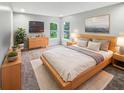 Serene bedroom with plush carpeting, natural light, and stylish wooden furniture at 770 Tulip Ln, Greenwood, IN 46143
