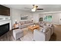Comfortable living room featuring a fireplace, ceiling fan, and neutral decor at 770 Tulip Ln, Greenwood, IN 46143