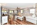 Spacious living room boasts hardwood floors, stylish furniture, and ample natural light at 7755 Dayflower Ct, Noblesville, IN 46062