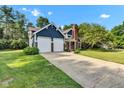 Charming two-story home featuring a brick chimney, two-car garage and beautifully landscaped yard at 8140 Bold Forbes Ct, Indianapolis, IN 46217