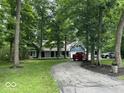 Home exterior boasts a long driveway, mature trees, and a well-manicured lawn at 8407 Campbell Ct, Mooresville, IN 46158
