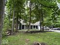 Home exterior boasts a long driveway, mature trees, and a well-manicured lawn at 8407 Campbell Ct, Mooresville, IN 46158