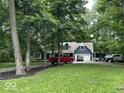 Home exterior boasts a long driveway, mature trees, and a well-manicured lawn at 8407 Campbell Ct, Mooresville, IN 46158