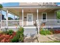 Inviting front porch with white railings, colorful flowers, and space to relax and enjoy the outdoors at 1129 Trowbridge St, Indianapolis, IN 46203