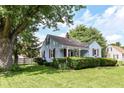 Traditional light blue home with a well-maintained lawn and mature trees at 114 South St, Southport, IN 46227