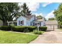 Light blue home with fenced-in yard and detached garage at 114 South St, Southport, IN 46227