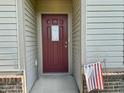 Inviting front door with decorative window and American flag, set in a cozy entrance at 1202 Tomahawk Pl, Martinsville, IN 46151