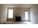 Bright living room featuring a modern fireplace and a sliding glass door for natural light at 12451 Cricket Song Ln, Noblesville, IN 46060