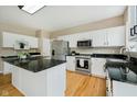 Well-lit kitchen with white cabinetry, a center island, and modern appliances at 12490 Windbush Way, Carmel, IN 46033