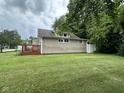 Spacious backyard featuring lush green grass and plenty of shade from mature trees at 1395 Evans Ave, Noblesville, IN 46060