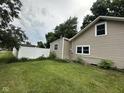 Side yard with green lawn and a bright white privacy fence at 1395 Evans Ave, Noblesville, IN 46060