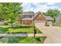 Beautiful brick two-story home with a manicured lawn and a three-car garage at 15075 Windsor Ln, Noblesville, IN 46060