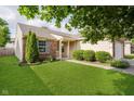 Charming home with lush green lawn, manicured bushes, and brick and siding accents at 16629 Greensboro Dr, Westfield, IN 46074