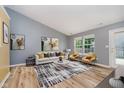 Bright living room with vaulted ceilings, wood floors, contemporary furniture, and lots of natural light at 16629 Greensboro Dr, Westfield, IN 46074