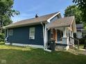 Quaint home with blue siding, brown roofing, and a lovely covered porch at 1810 N Parker Ave, Indianapolis, IN 46218