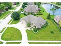 An aerial view displays the home with well-maintained landscaping, pond, and a three-car garage at 182 Southwind Ln, Greenwood, IN 46142