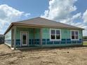 View of a newly constructed home featuring bright white windows and a glass-paned door, ready for customization at 201 Holly Ln, Greenfield, IN 46140